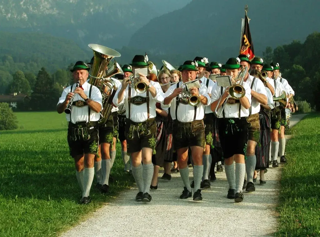 Bavarian brass band marching in traditional Lederhosen clothing - Lederhosen For Sale