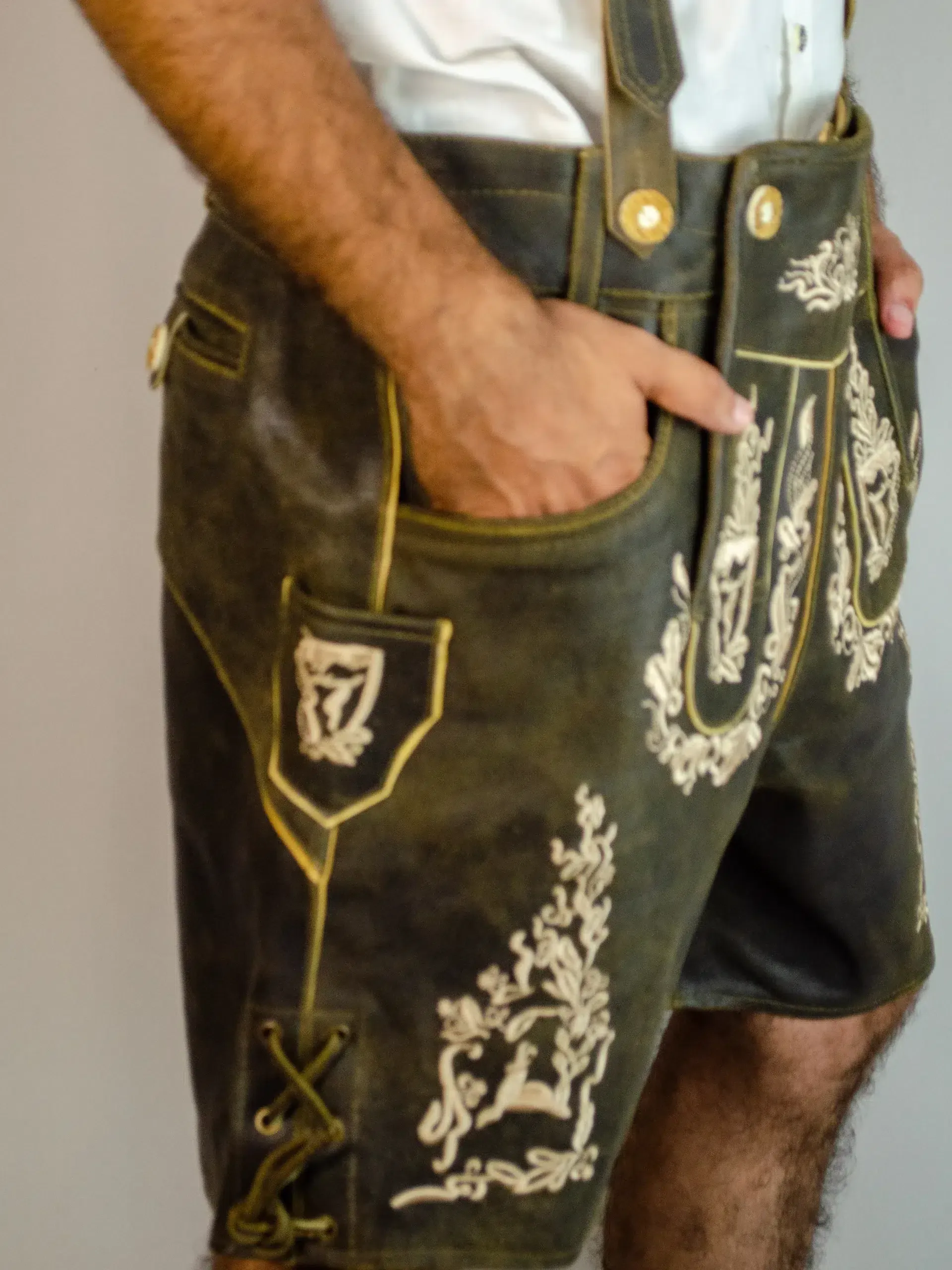 Side view close-up of man in brown embroidered Lederhosen. - Lederhosen For Sale