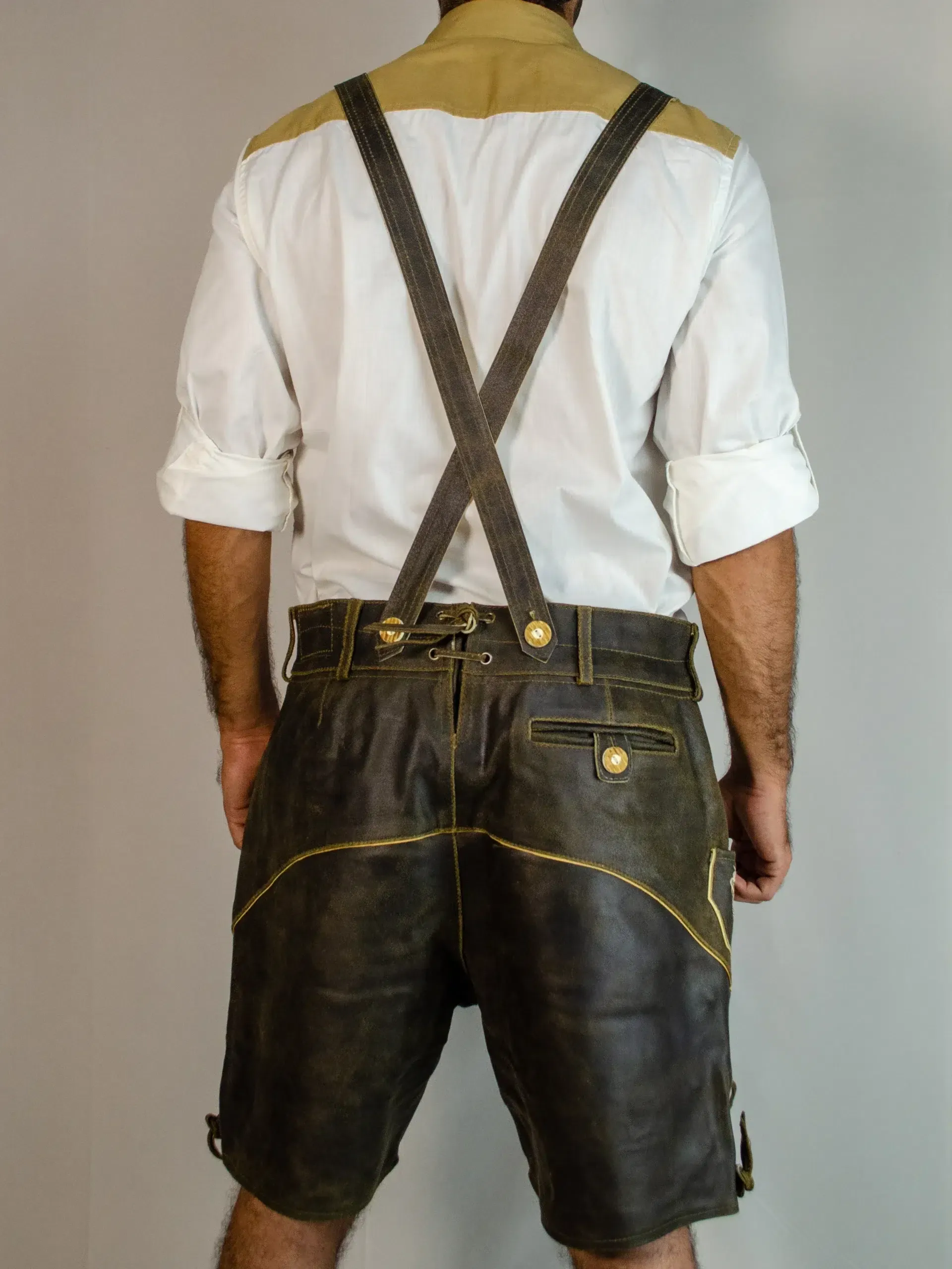 Rear view of man in brown Lederhosen and white shirt. - Lederhosen For Sale